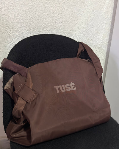 Brown tote on a chair